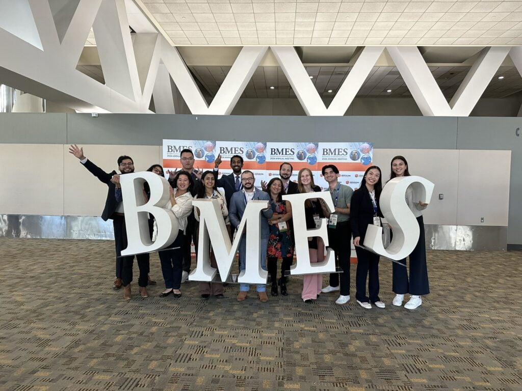 A group of people pose with a BMES sign.