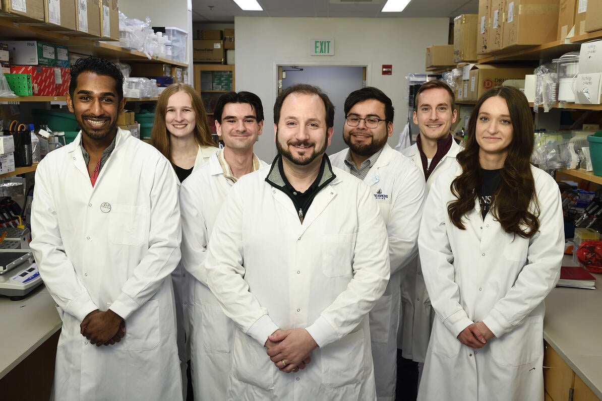 Joshua Doloff, center, with colleagues